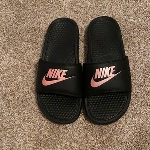 black & rose gold nike slides.